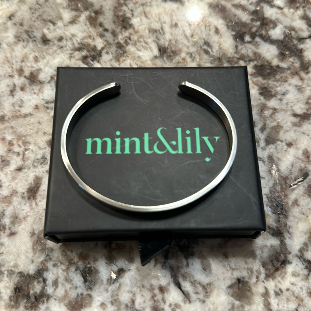 Never worn  mint and lily silver bracelet.  Inscription inside.